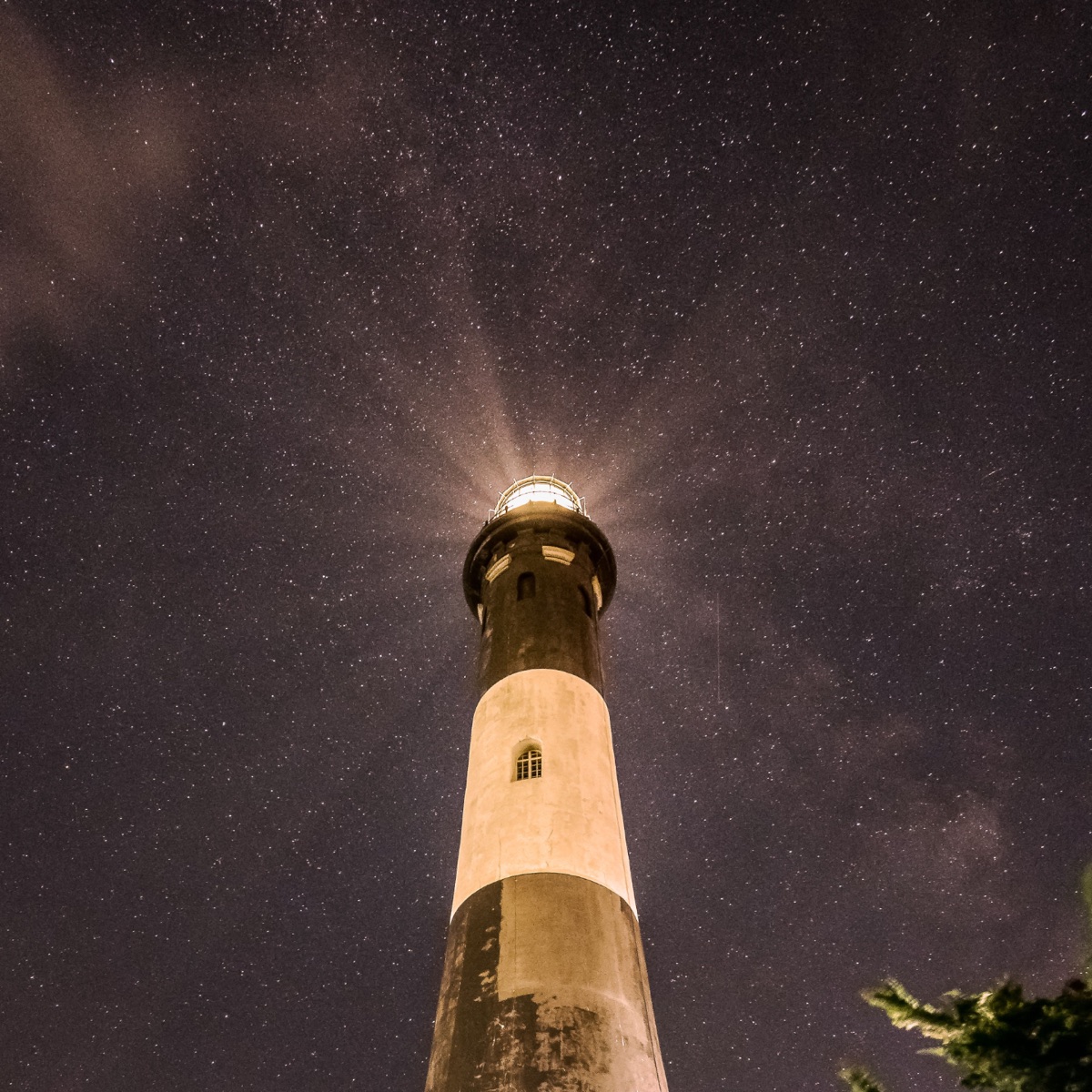 A lighthouse beam against a night sky